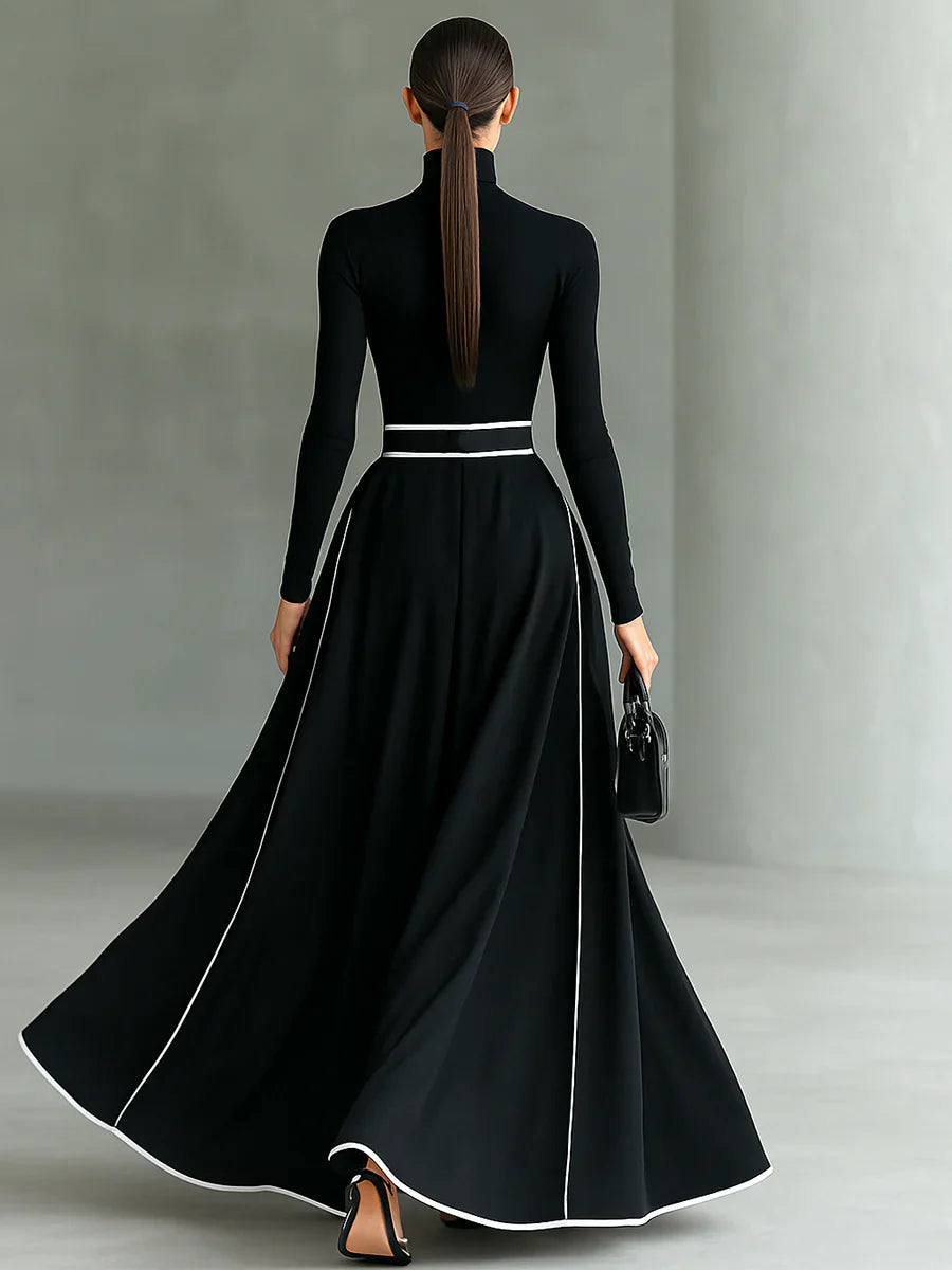 Adriana - Vestido largo negro con costuras blancas, cuello alto y cinturón ajustado